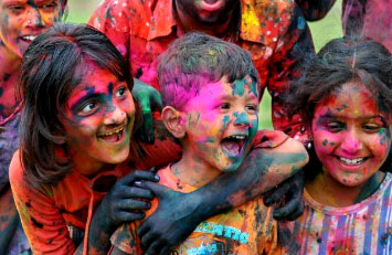 Children play Holi with fun and frolic.